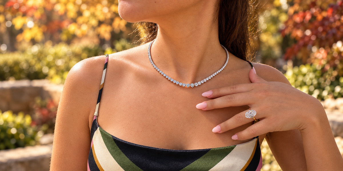 Diamond engagement ring with cream knitwear in an autumn setting