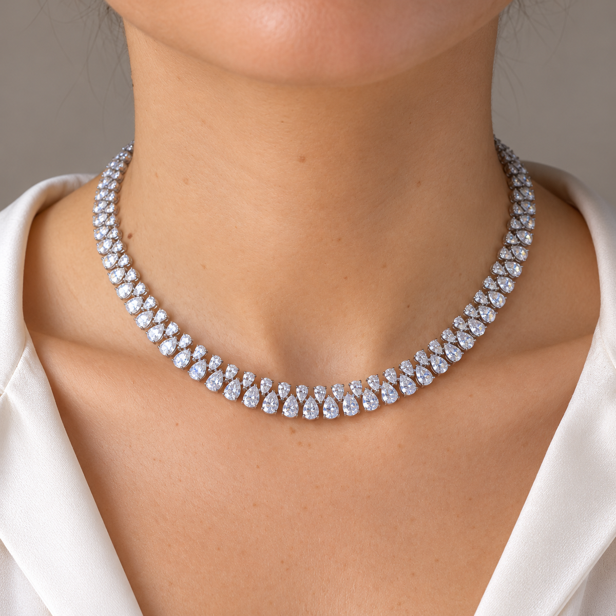 Alternating pear diamond necklace worn on neck