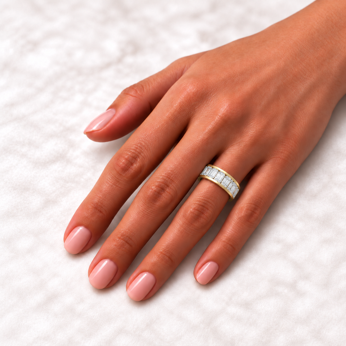 Emerald-cut channel-set lab-grown diamond eternity band, 5 x 3 mm diamonds, 14K yellow gold, on-hand view
