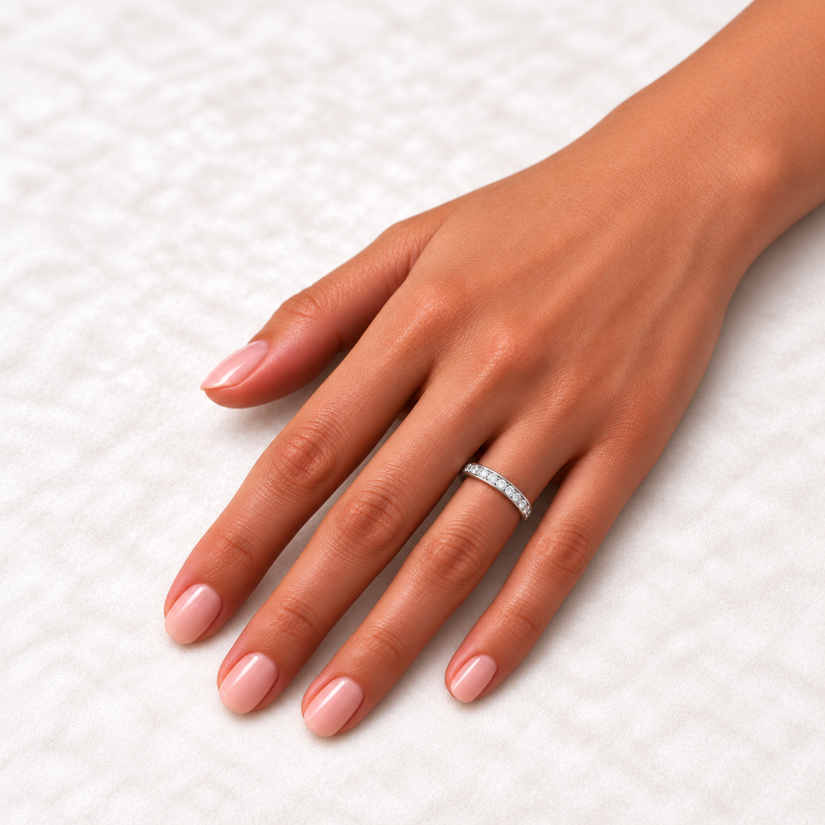 14K White Gold round channel-set lab-grown diamond eternity band, 2 mm diamonds, on-hand view