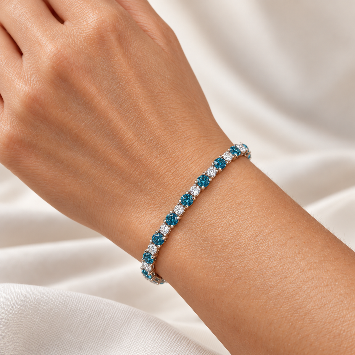 Fancy Vivid Blue and white lab-grown diamond Plus & Minus bracelet in 14k white gold, 4 mm bracelet shown on wrist