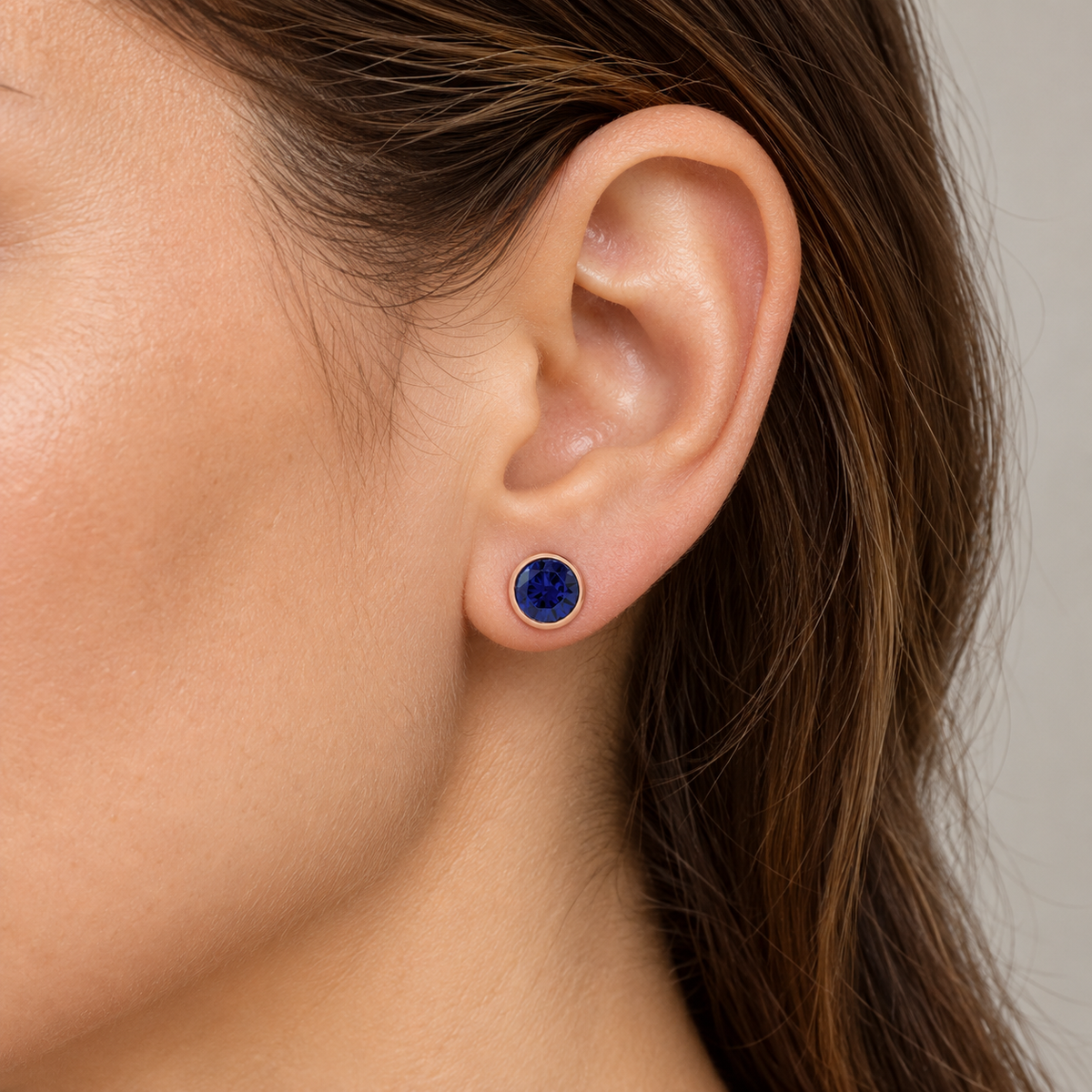 14K Gold Lab-Grown Gemstone Bezel Stud Earrings — Lab-Grown Blue Sapphire / 14K Rose Gold / 6 mm — illustrative on-ear view