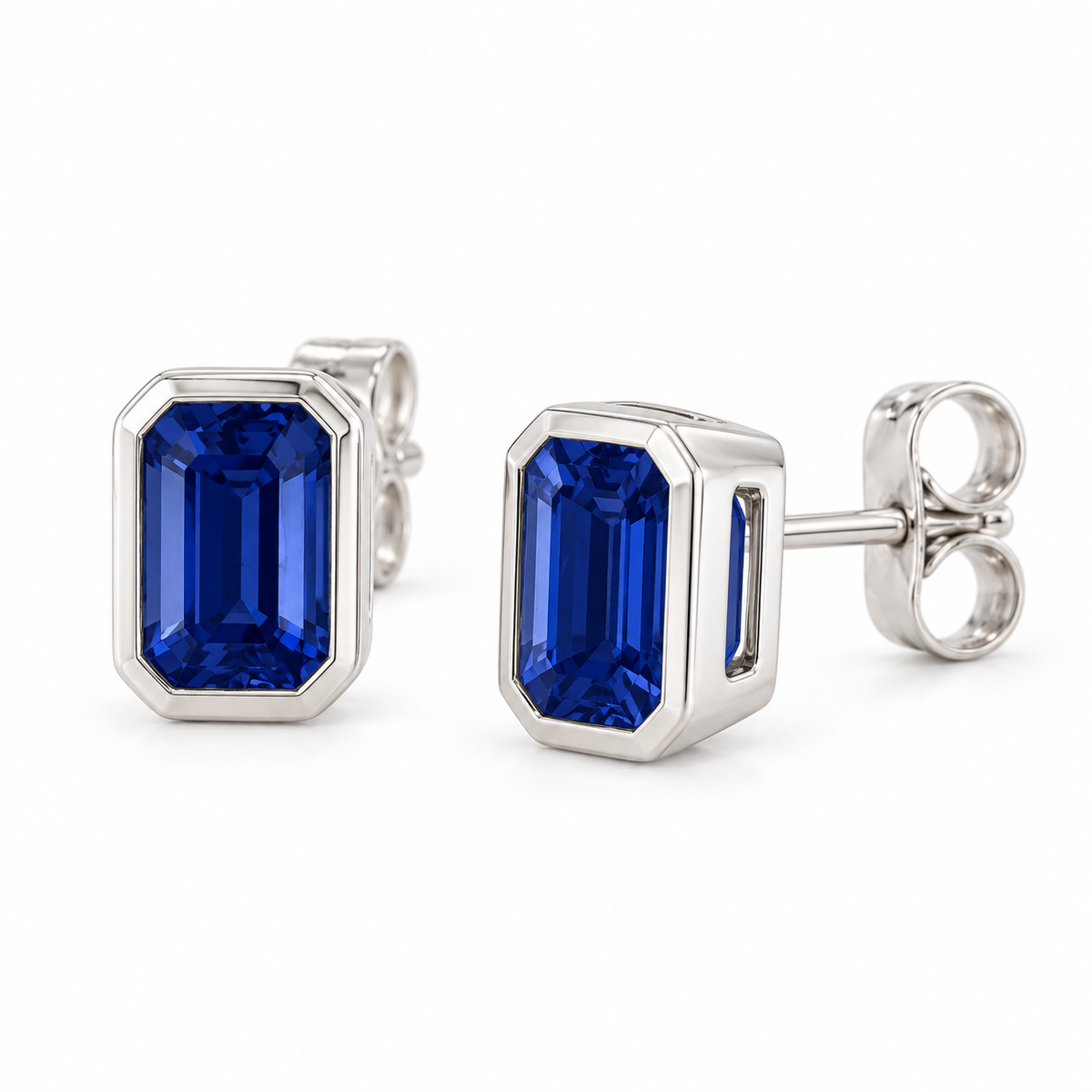 14K White Gold Lab-Grown Blue Sapphire Emerald-Cut Bezel Stud Earrings — 6 × 4 mm stones — enhanced studio view