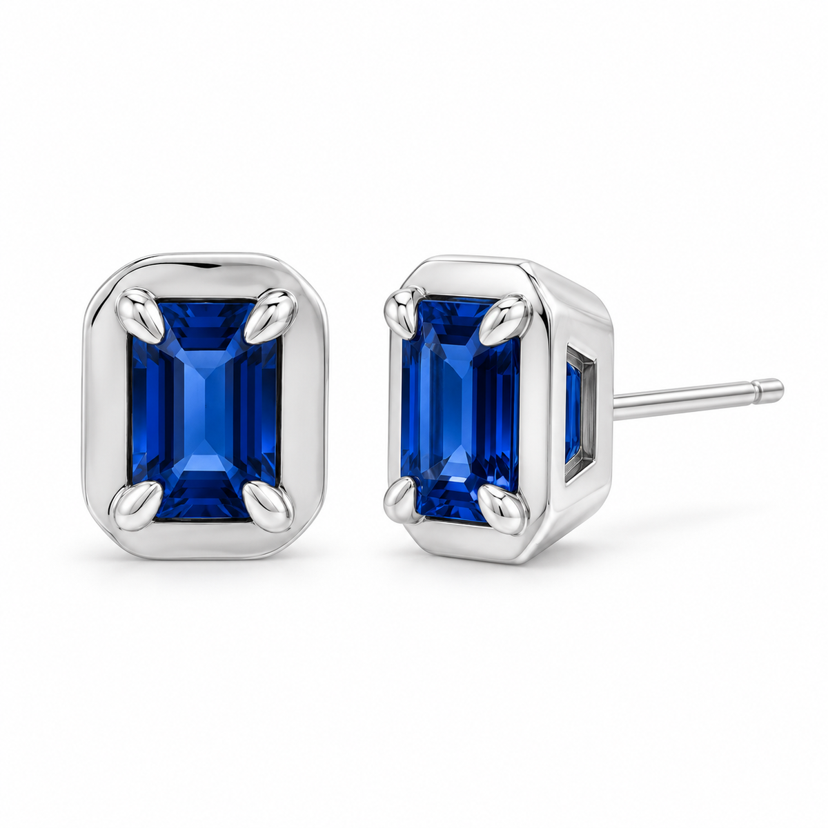 14K White Gold Lab-Grown Blue Sapphire Emerald-Cut Claw Bezel Stud Earrings — 6 × 4 mm stones — enhanced studio view