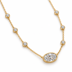 Angled detail of yellow gold oval bezel diamond necklace