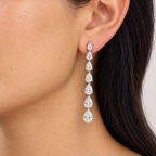 Pear diamond drop earring worn on ear