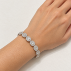 Oval halo lab-grown diamond bracelet worn on a woman's wrist