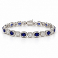 Front view of women's oval lab-grown sapphire and diamond halo bracelet in 14k white gold