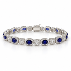 Front view of women's oval lab-grown sapphire and diamond halo bracelet in 14k white gold