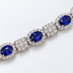 Close-up of blue oval lab-grown sapphire halos and lab-grown diamond links